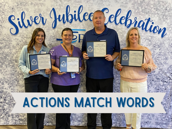 Four Springs Charter Schools staff members pose with certificates in front of a “Silver Jubilee Celebration” backdrop, holding awards for their exemplary service.
