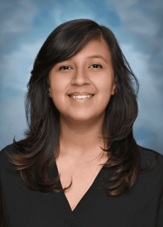 Professional headshot of a smiling employee against a neutral background.