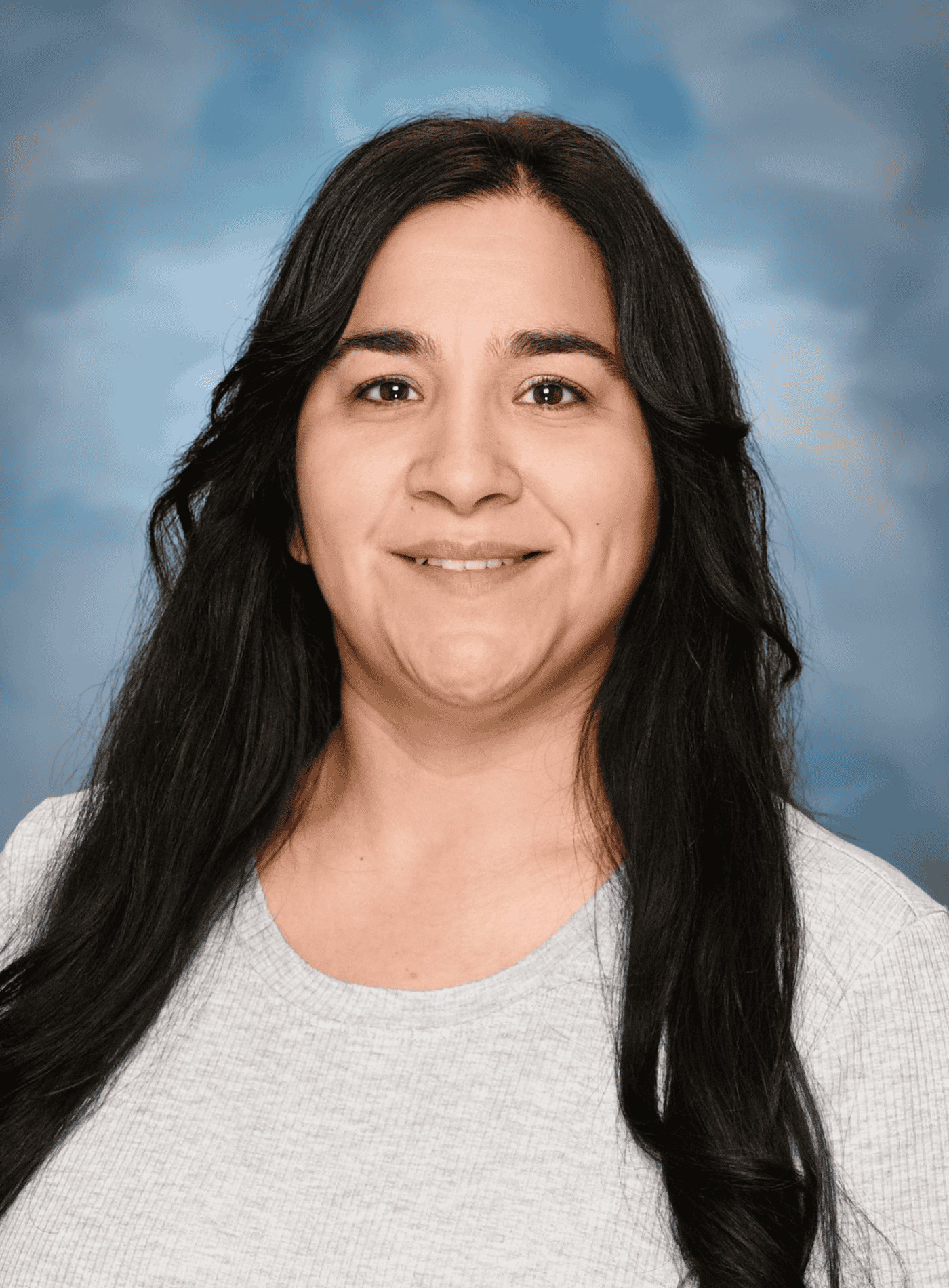 Professional headshot of a smiling employee against a neutral background.