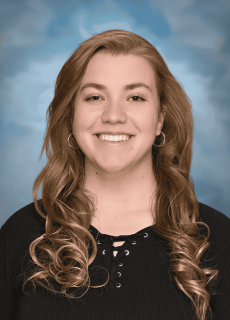 Professional headshot of a smiling employee against a neutral background.