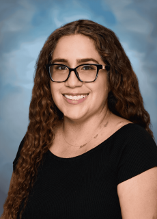 Professional headshot of a smiling employee against a neutral background.