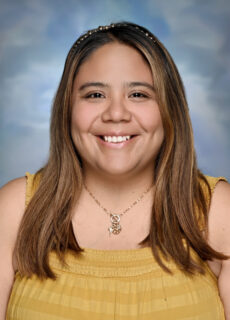 Professional headshot of a Springs Charter Schools staff member smiling against a neutral studio background.
