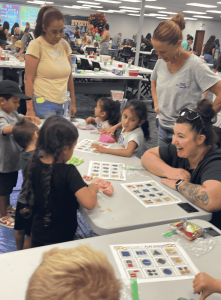 Families and children participate in math-themed games and activities at a Springs Charter Schools event.