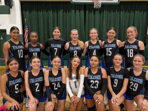 River Springs Charter Schools girls volleyball team posing together in uniform on the court.