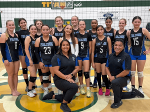 River Springs Charter Schools volleyball team and coaches pose together on the court after a successful season.