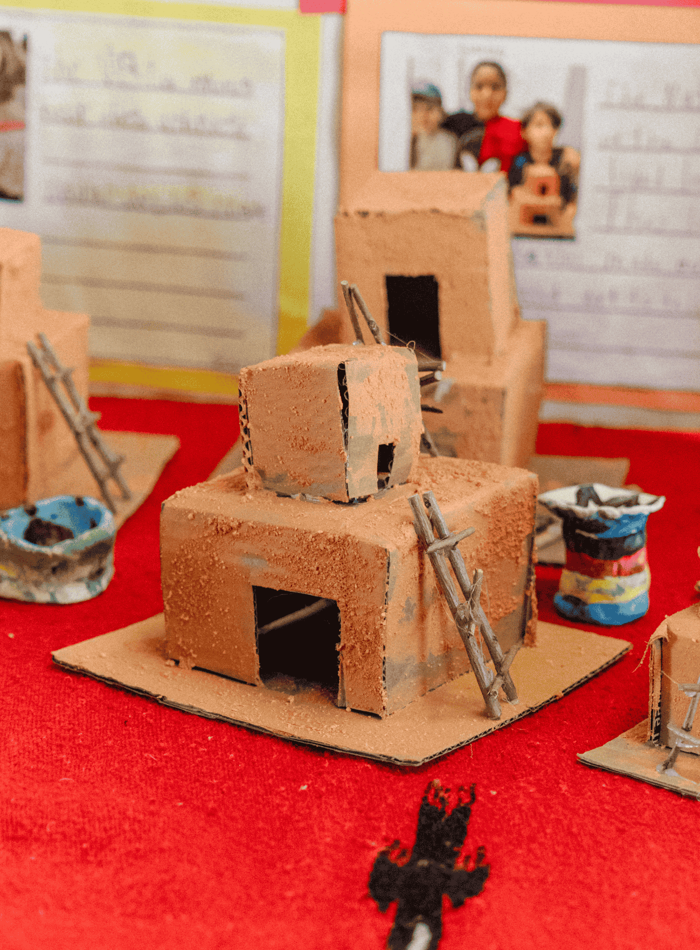 Student-created model structures displayed on a table during a Springs Charter Schools cultural learning project.