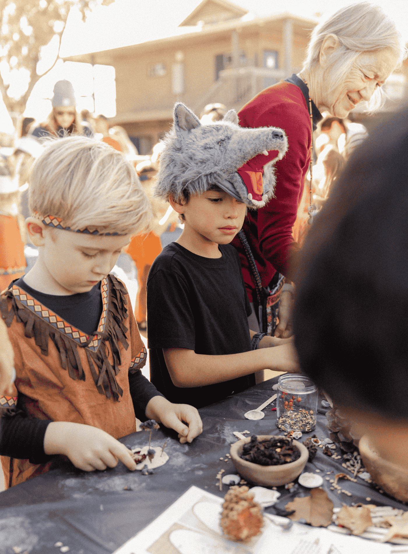 Springs Charter Schools students participate in a hands-on cultural learning activity using natural materials.