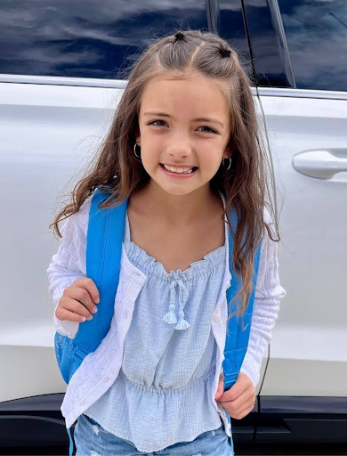 Springs Charter Schools student smiling outdoors while wearing a backpack on the first day of school.