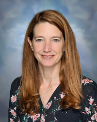 Professional staff portrait of a Springs Charter Schools team member in business attire.