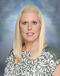 Professional staff portrait of a Springs Charter Schools team member in business attire.