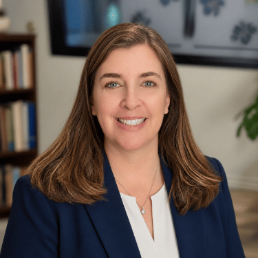 Professional portrait photo of Superintendent Dr. Kathleen Hermsmeyer smiling in a navy blue blazer.
